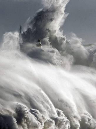 Large waves hit Mouro island in front of port in Santander